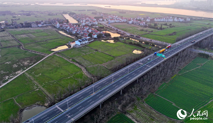 南昌縣南新鄉西江村，車輛在繞城高速公路上疾馳，沿線鄉村春景怡人。人民網 朱海鵬攝