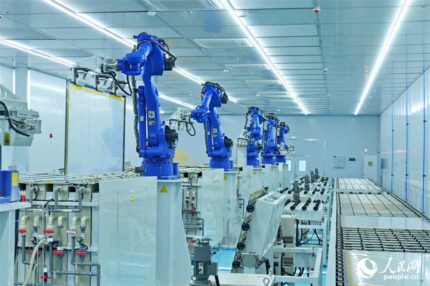 一排排智能機器人正轉動機械臂加工透明導電膜。人民網 朱海鵬攝