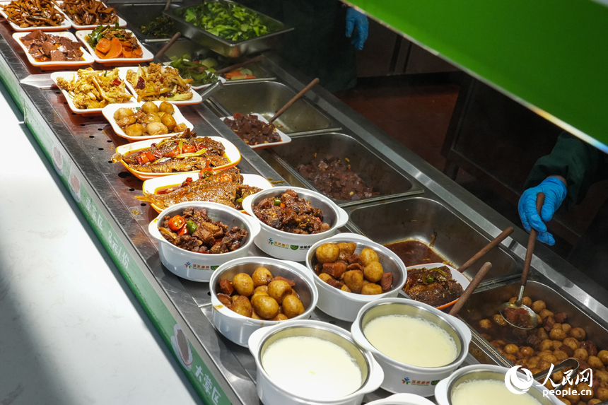 江西省南昌市東湖區光明社區幸福食堂，打菜窗口上擺放著剛出鍋的菜品。人民網 孔文進攝