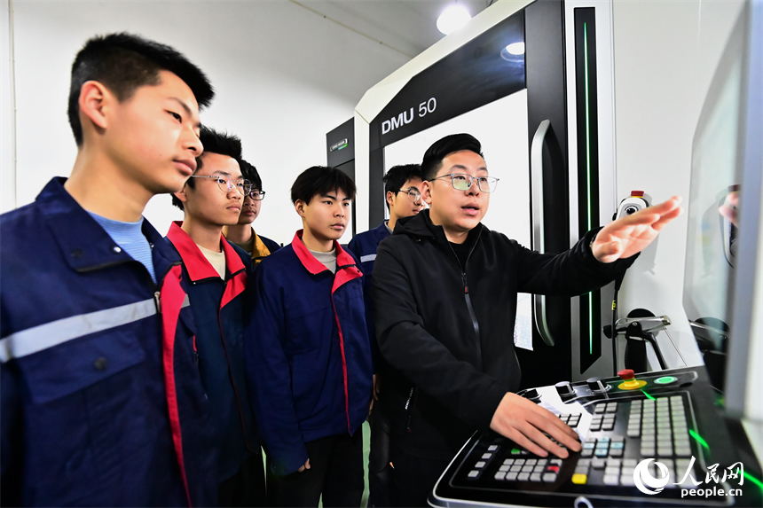 上饒市弋陽中等職業學校工業機器人實訓基地，學生在學習智能機械臂操作技能和編程知識。人民網 朱海鵬攝