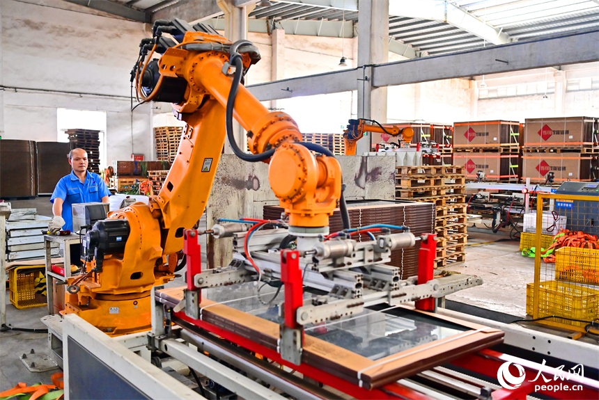 豐城市的一家陶瓷有限公司智能化生產車間，工業機器人在自動化生產線上作業。人民網 朱海鵬攝
