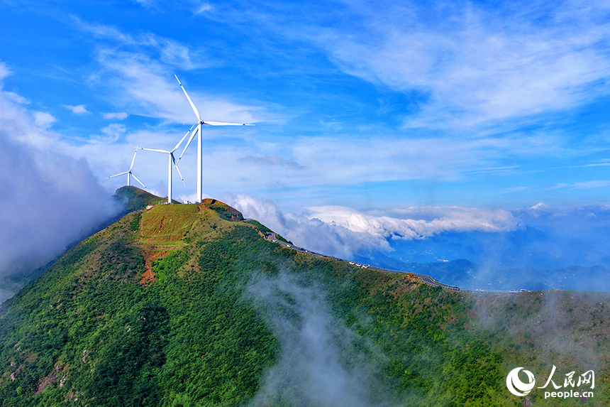 贛州市上猶縣雙溪草山，一臺臺風力發電機迎風旋轉，吸引許多游客前來觀賞“云蒸霞蔚、風葉飛旋”的獨特美景。人民網 朱海鵬攝