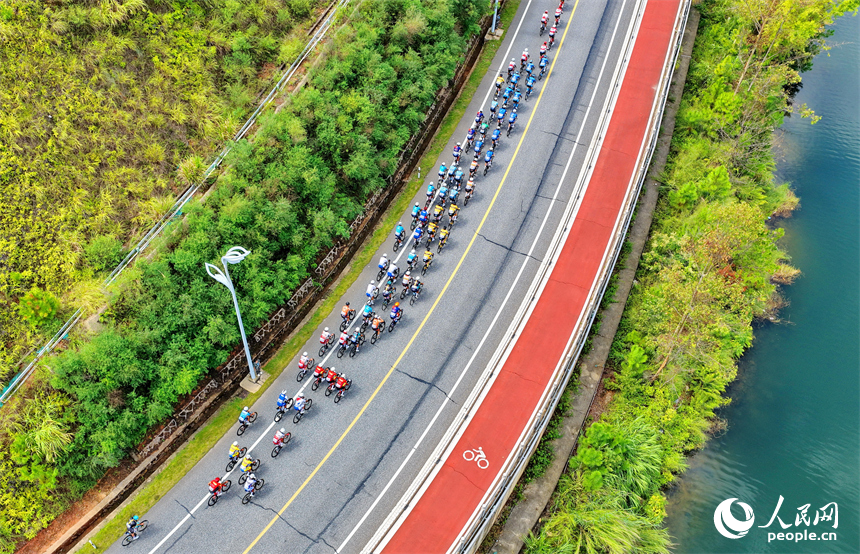 贛州市上猶縣南湖國家濕地公園，騎手在沿湖公路進行自行車騎行比賽，公路沿線風景秀美。人民網 朱海鵬攝