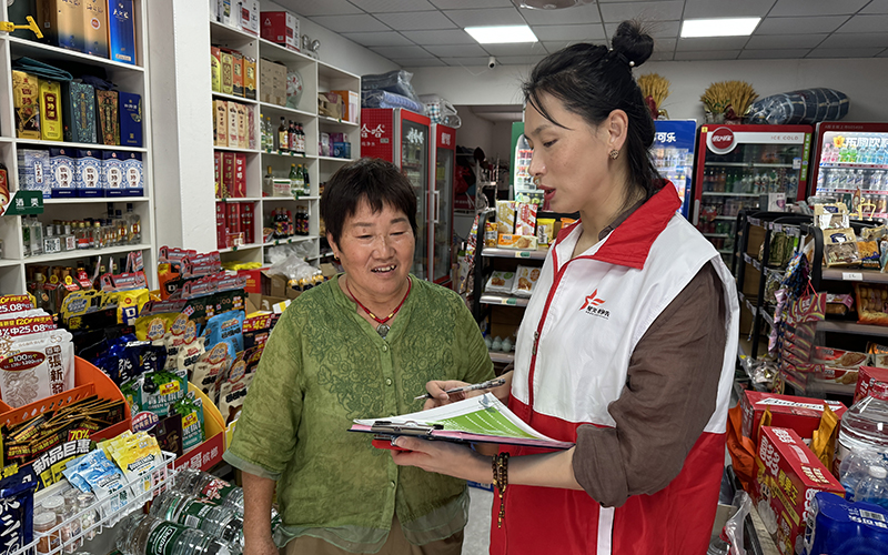 圖為志愿者為客戶講解《老年人權益保障法》。楊珉攝