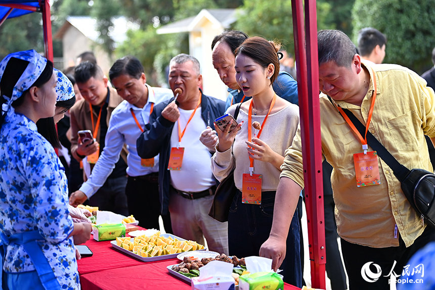 采購商和游客前來洽談臍橙訂單，品嘗臍橙特色美食。人民網 朱海鵬攝